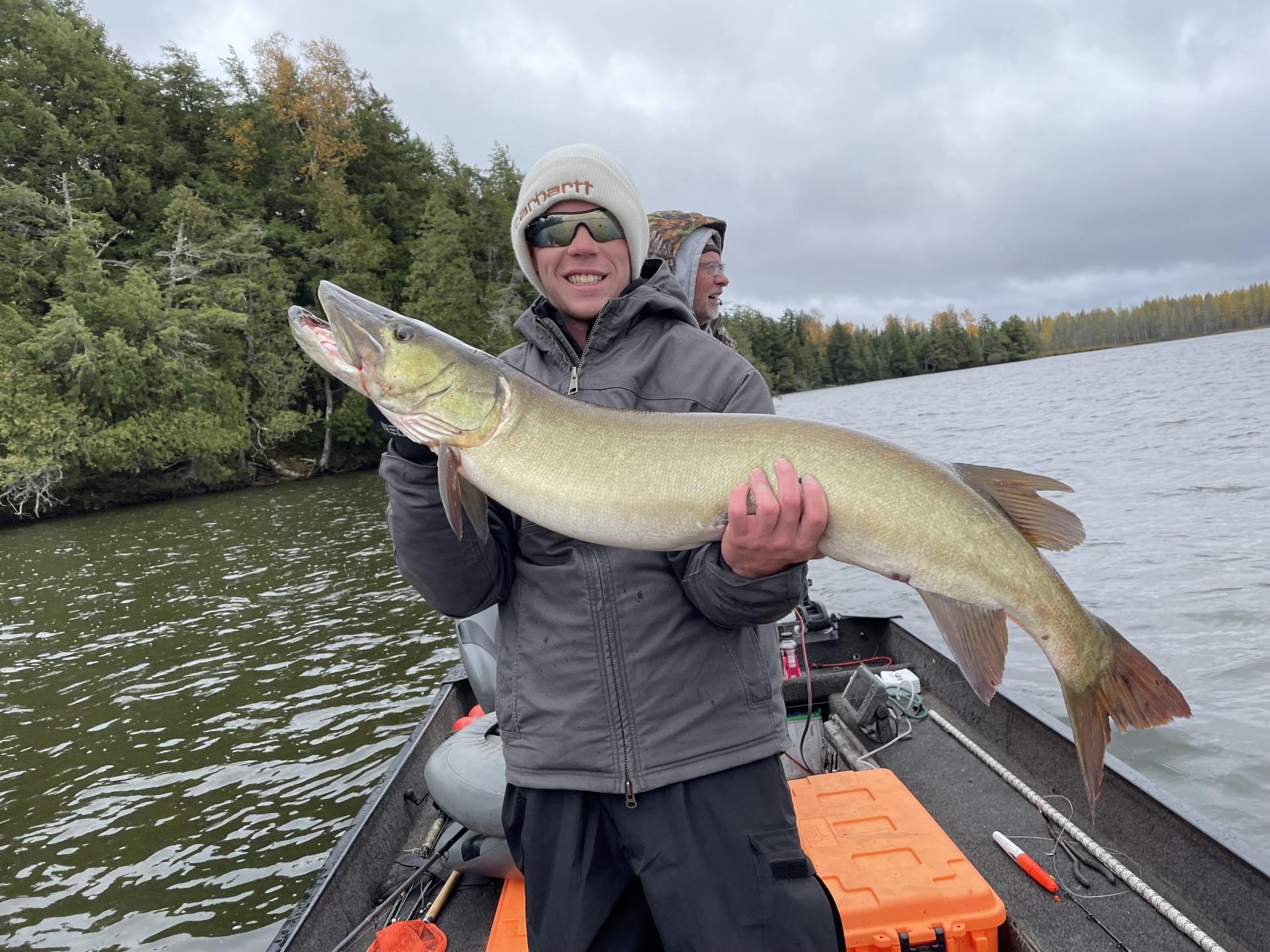 fisherman holding a large musky