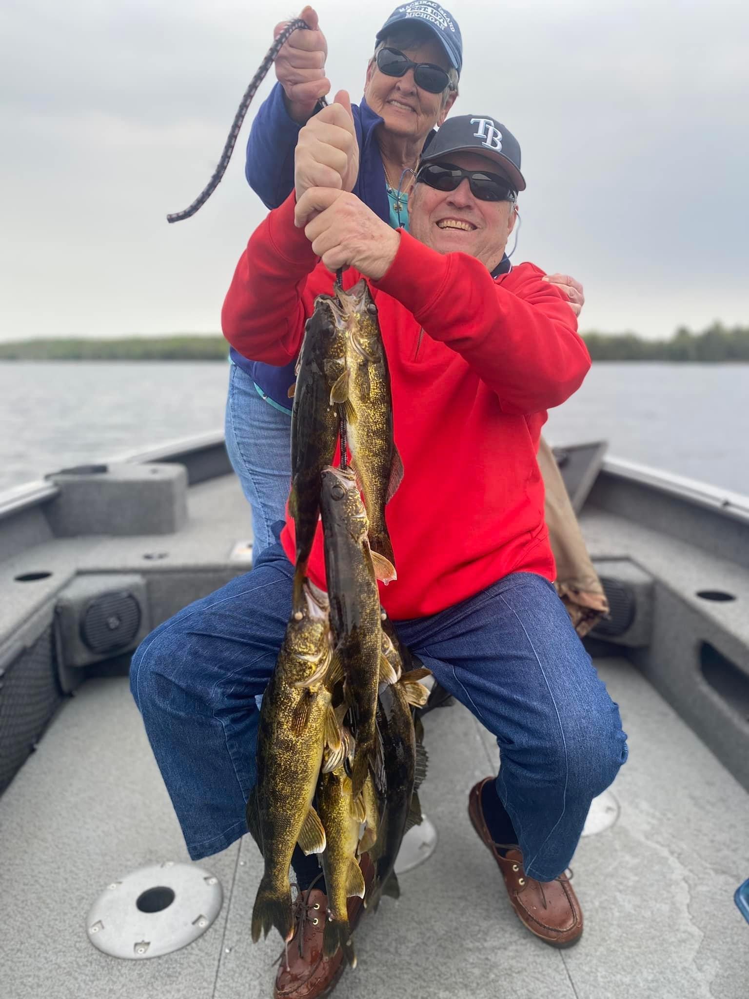 man and woman holding their large catch